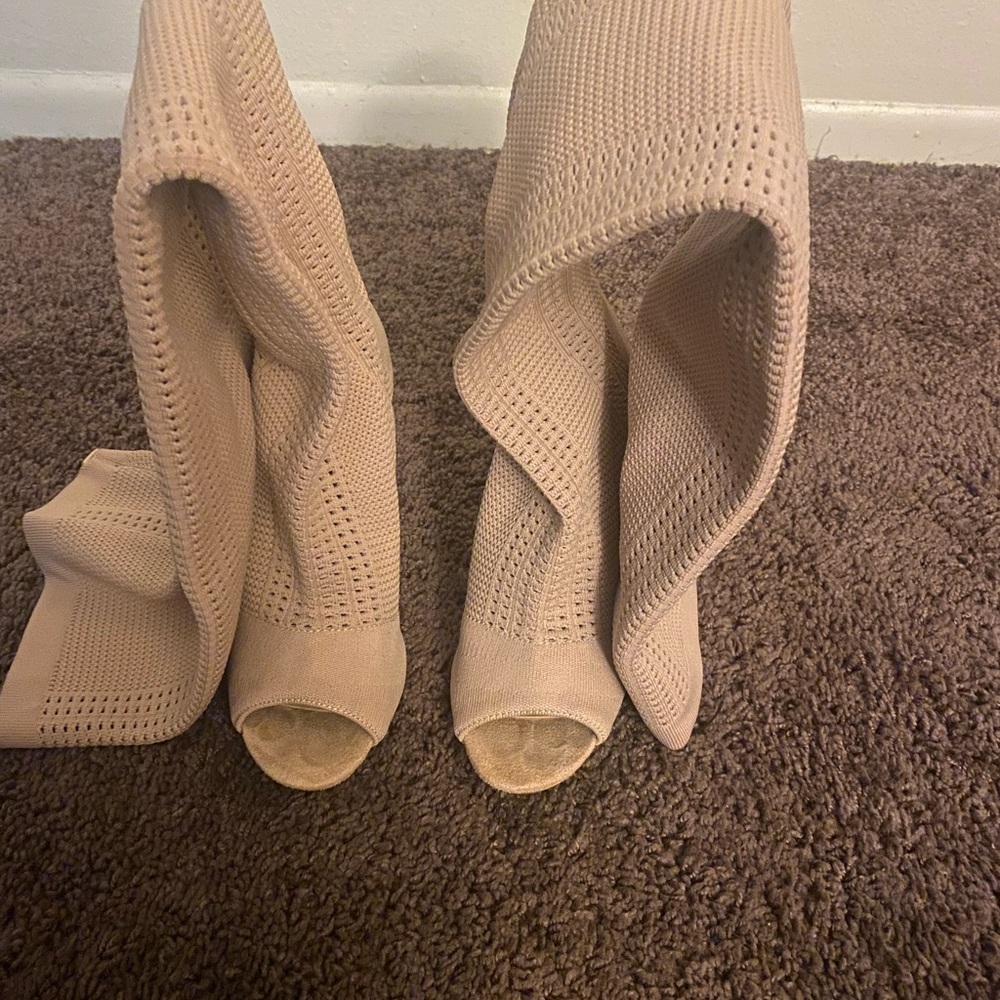 Nude knee high open toe boots.